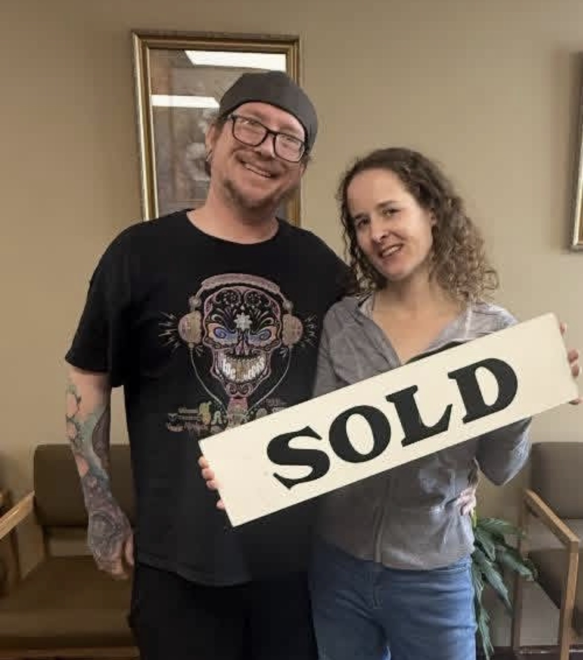 Michael and Mariah holding the SOLD sign